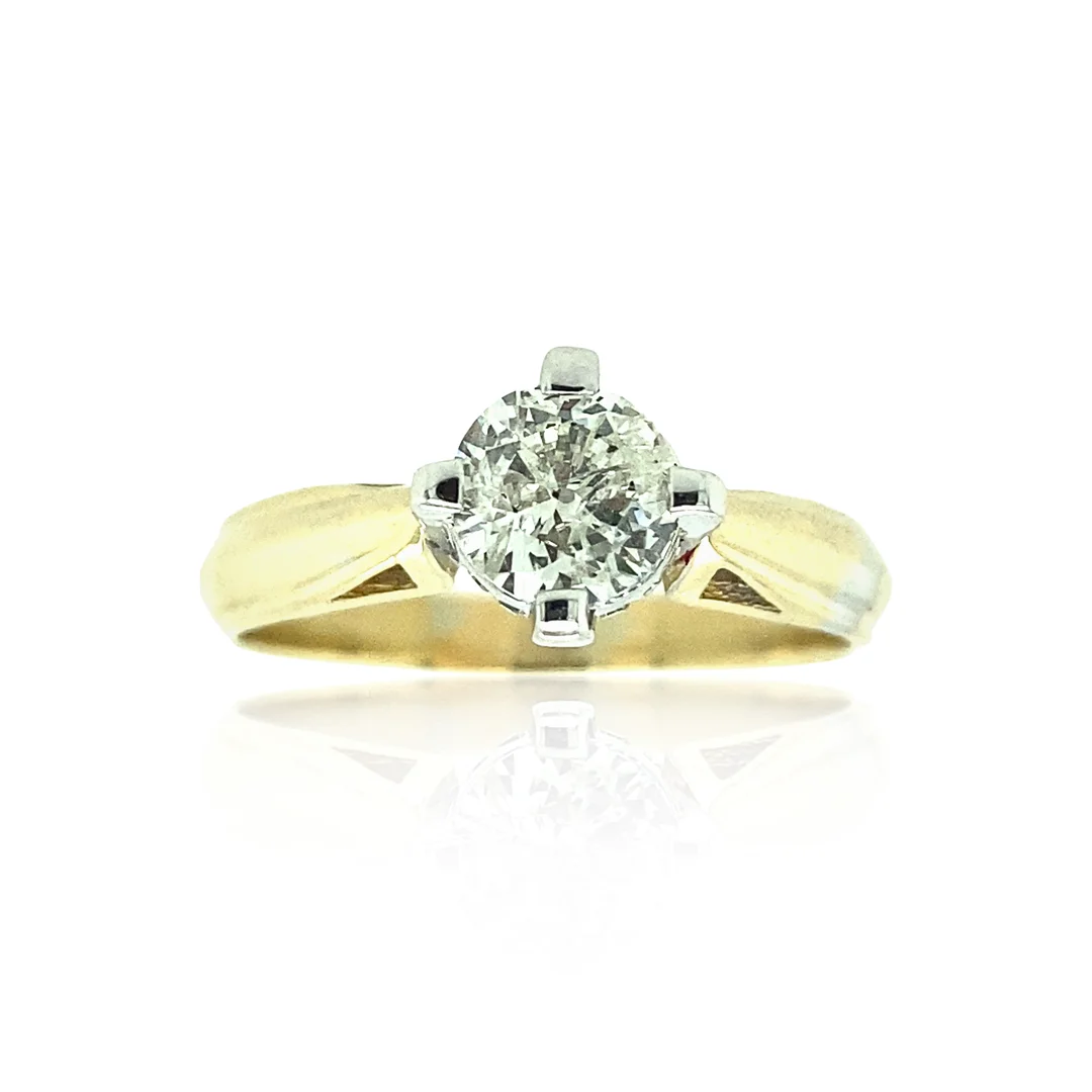 user-inserted A two-tone gold four-prong compass-style round diamond solitaire engagement ring on a white background with a slight reflection.