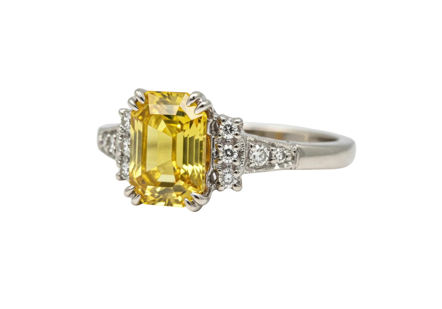 A yellow diamond engagement ring with double claw prongs on the center yellow diamond on an isolated white background.