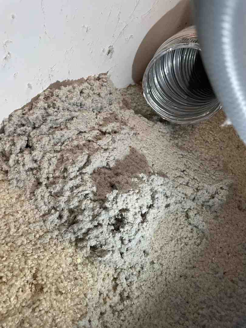 A technician inspecting the back of a clothes dryer - dryer vent cleaning frederick md