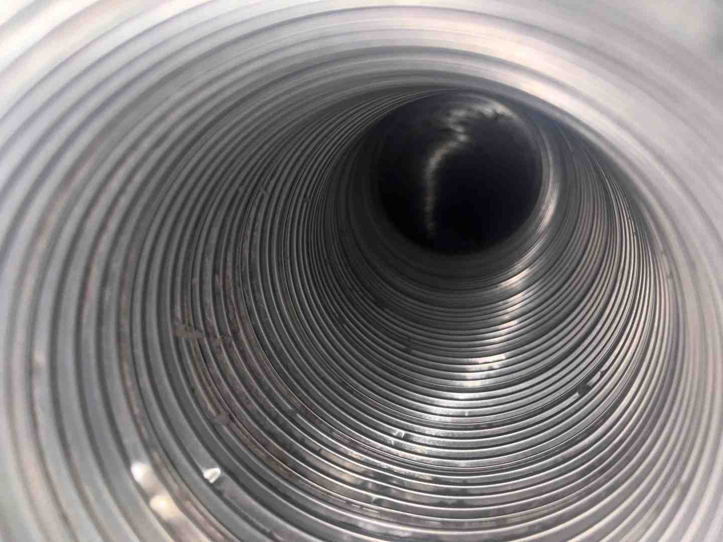 A technician cleaning inside the dryer chassis - dryer vent cleaning frederick md