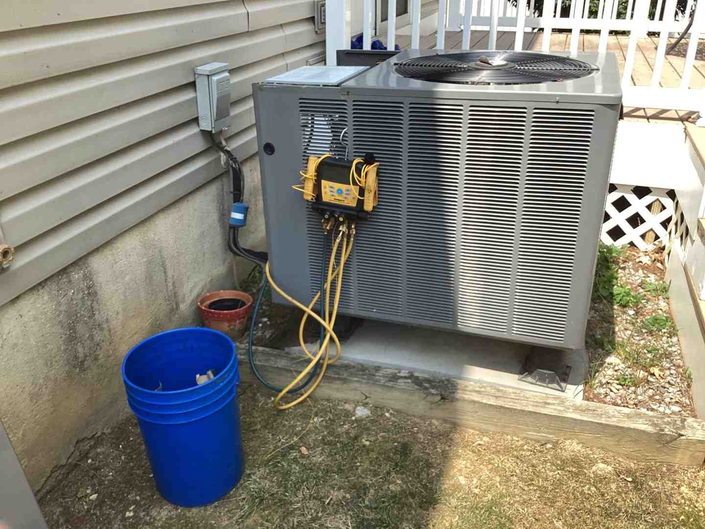 technician performing maintenance on a new HVAC unit - hvac installation frederick md
