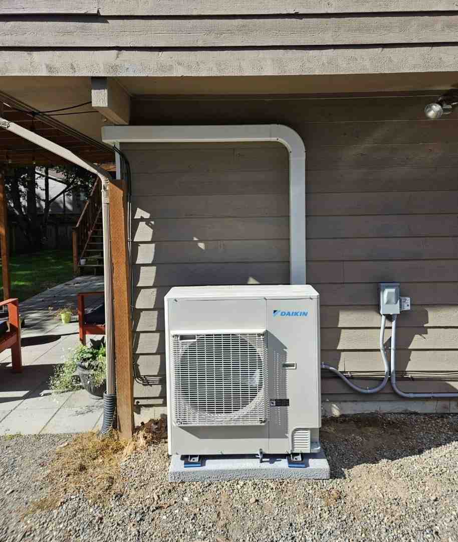 infographic showing how a heat pump transfers heat from outside air into your home during winter and removes heat from inside during summer, with arrows illustrating the refrigerant cycle and labeled components including outdoor unit, indoor unit, compressor, and refrigerant lines - heat pump installation auburn wa