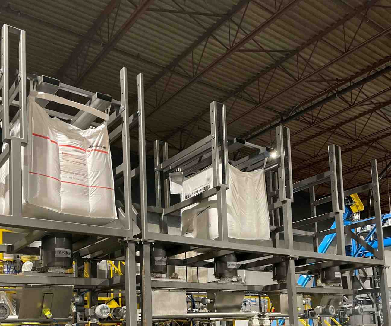 automated system precisely placing a bulk bag onto an unloader - automated bulk bag unloading automated system precisely placing a bulk bag onto an unloader - automated bulk bag unloading