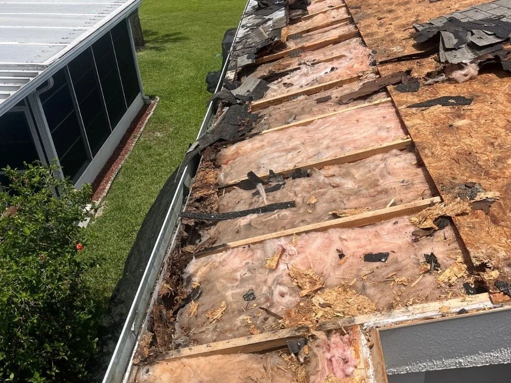user-inserted Water-damaged roof decking and torn underlayment from delayed roofing maintenance.