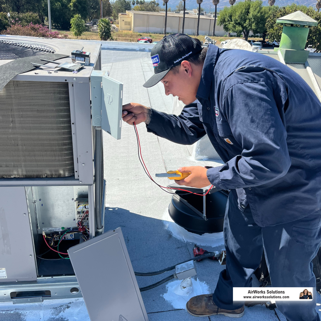 technician servicing an outdoor AC unit - hvac tune up roseville
