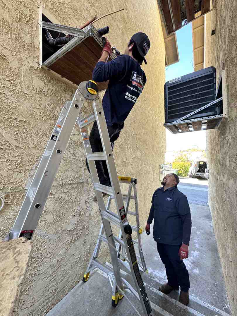 image of an HVAC technician talking with a homeowner - emergency heating repair ventura ca