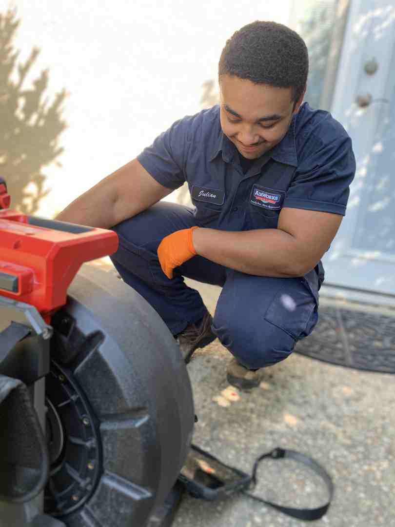 plumber inspecting a pipe under a sink - plumbing service camarillo ca plumber inspecting a pipe under a sink - plumbing service camarillo ca