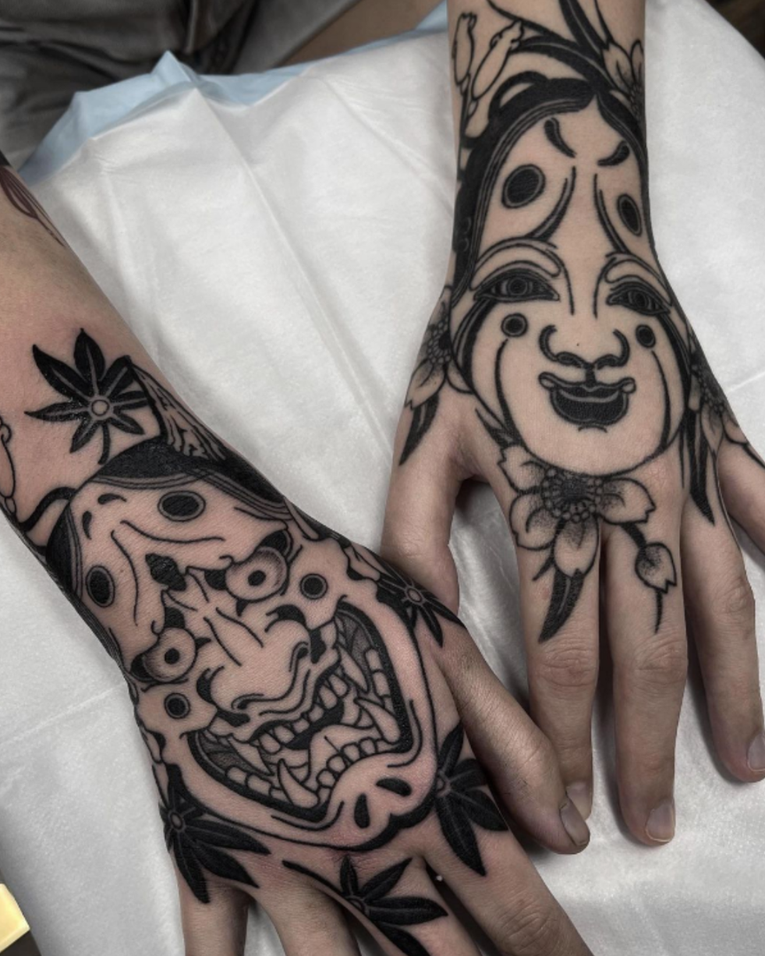 Black and grey Japanese hand tattoos featuring Irezumi imagery in monochrome.
