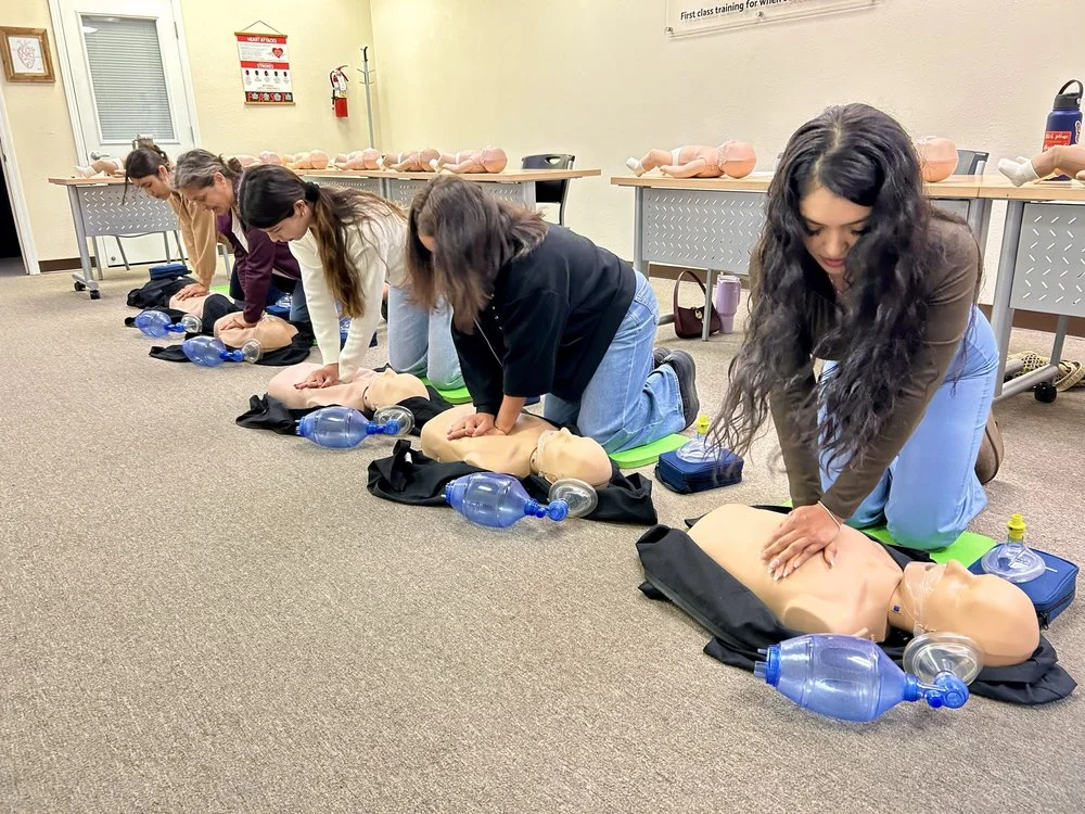 Illustration of students practicing high-quality chest compressions in a clean classroom setting