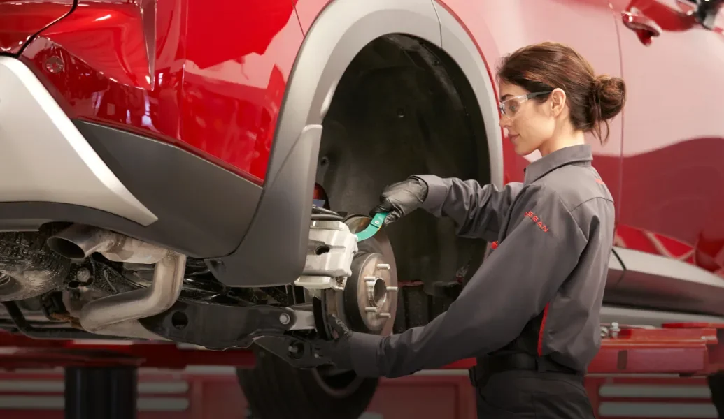 Automotive technician checking diagnostic systems with an electronic tablet tool
