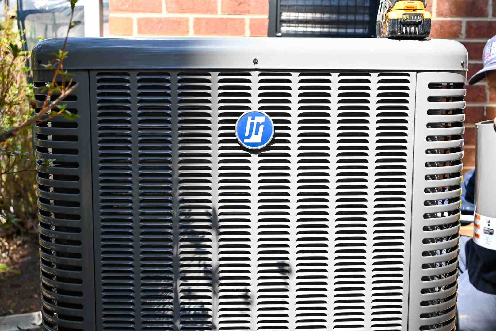 modern high-efficiency heat pump unit outside a home - heating installation in glen allen, va