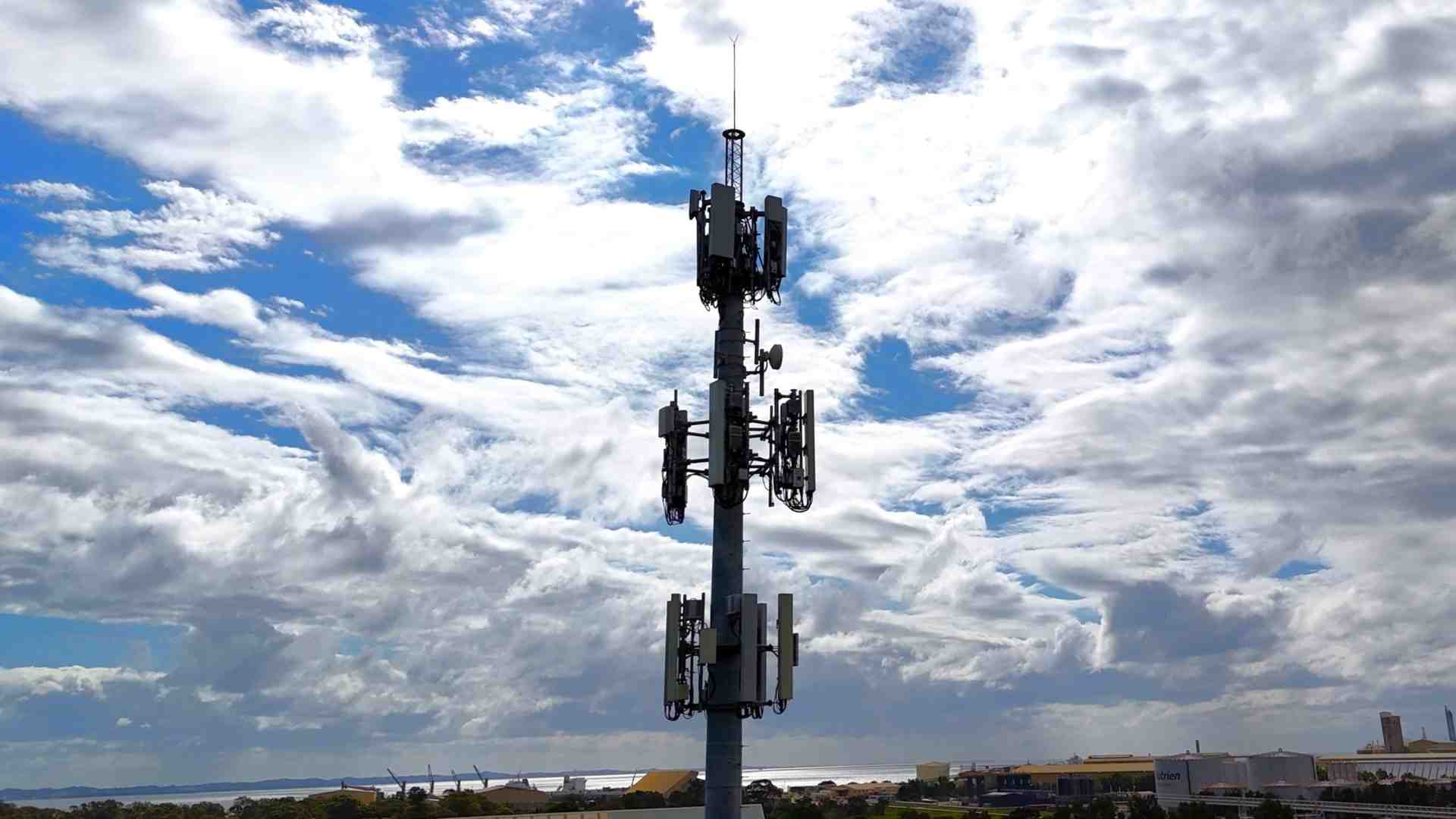 Communication tower (monopole) integrated into an urban landscape - poles and towers Communication tower (monopole) integrated into an urban landscape - poles and towers