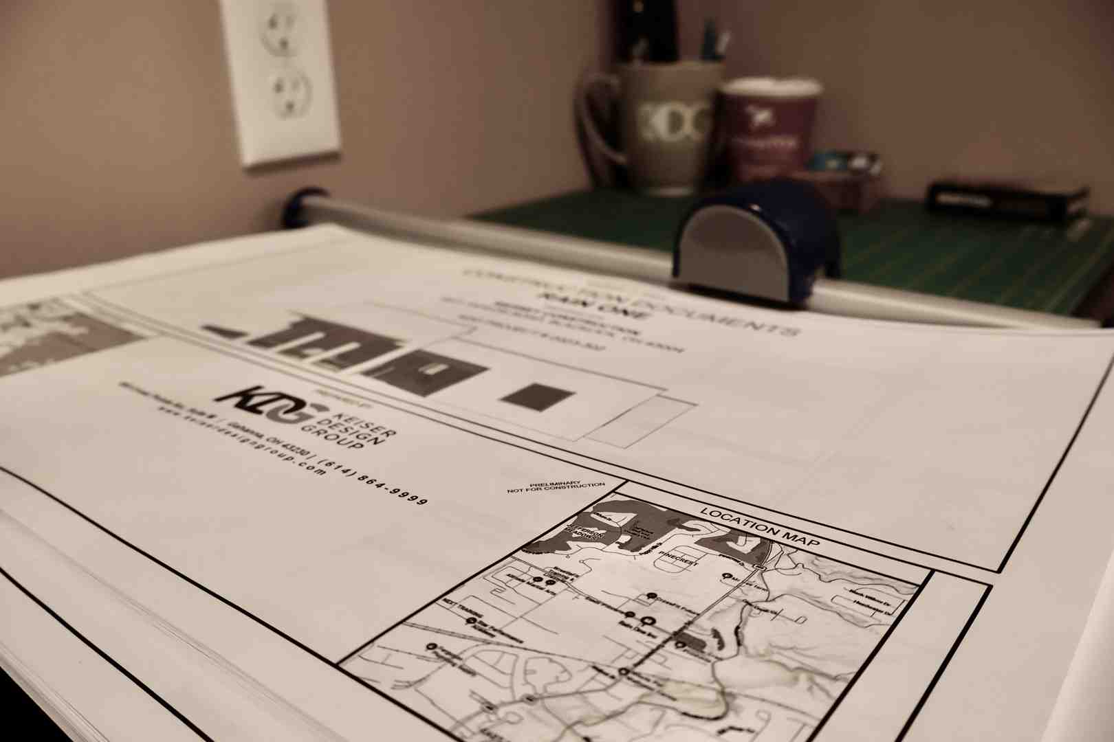 commercial architects reviewing construction blueprints on site