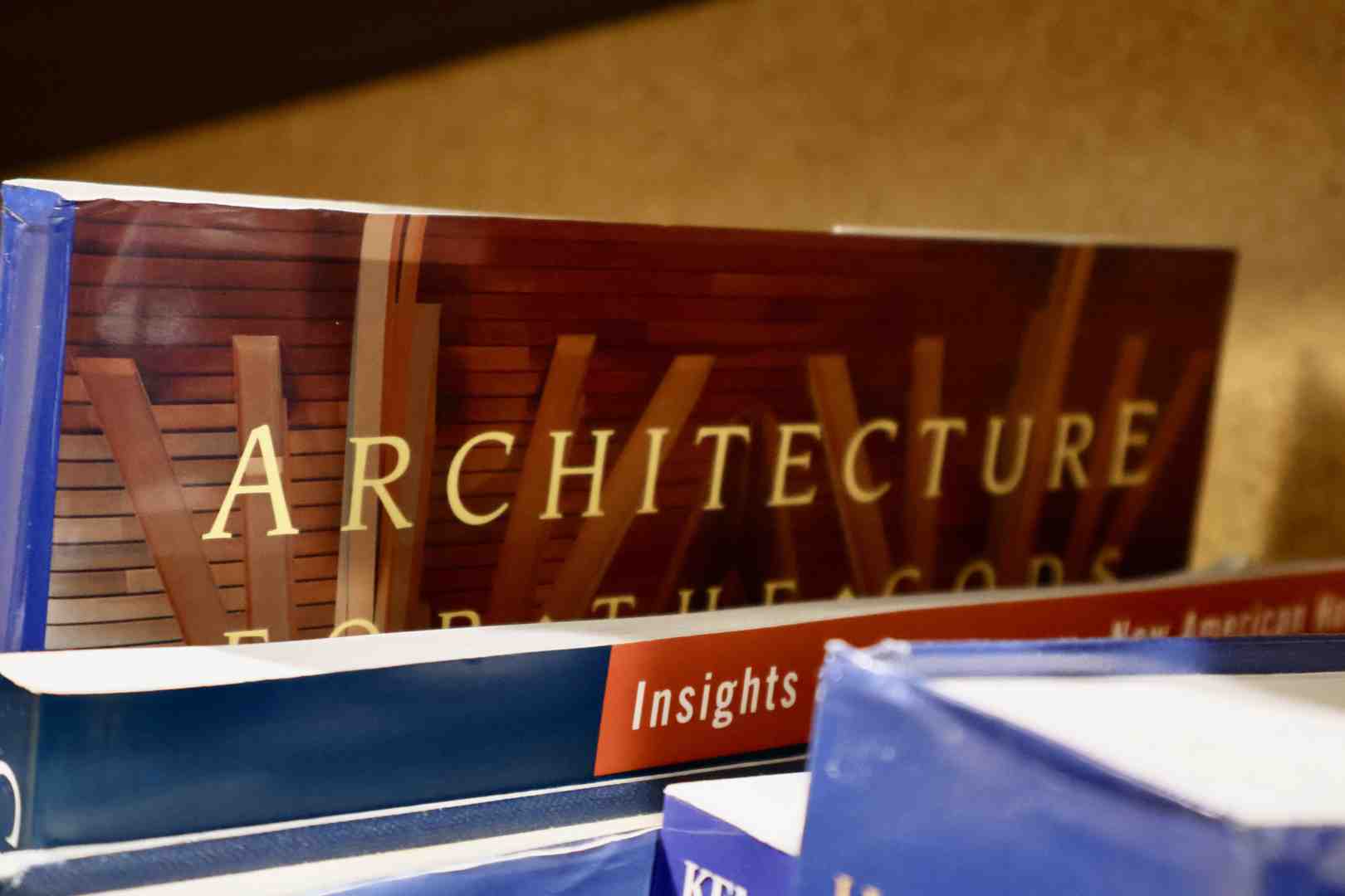 Architectural books on a table in a church interior.