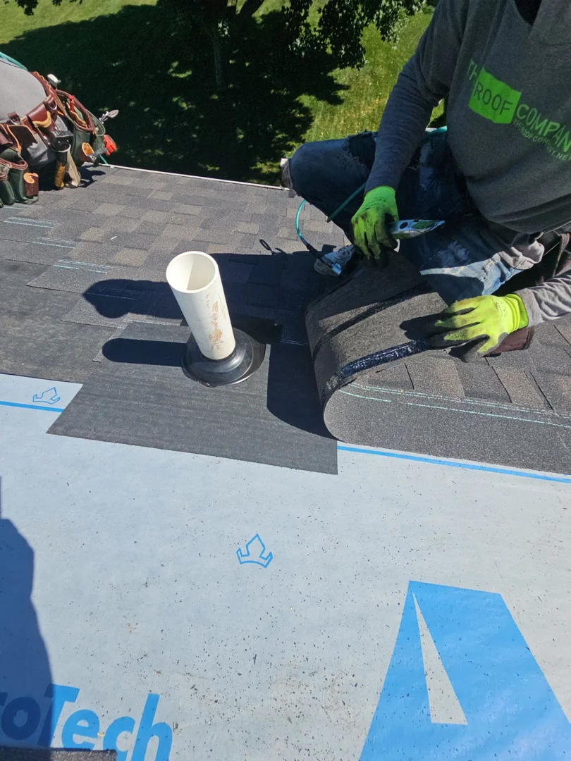 Roofing crew safely replacing shingles on a steep two-story residential home in Wixom, MI Roofing crew safely replacing shingles on a steep two-story residential home in Wixom, MI