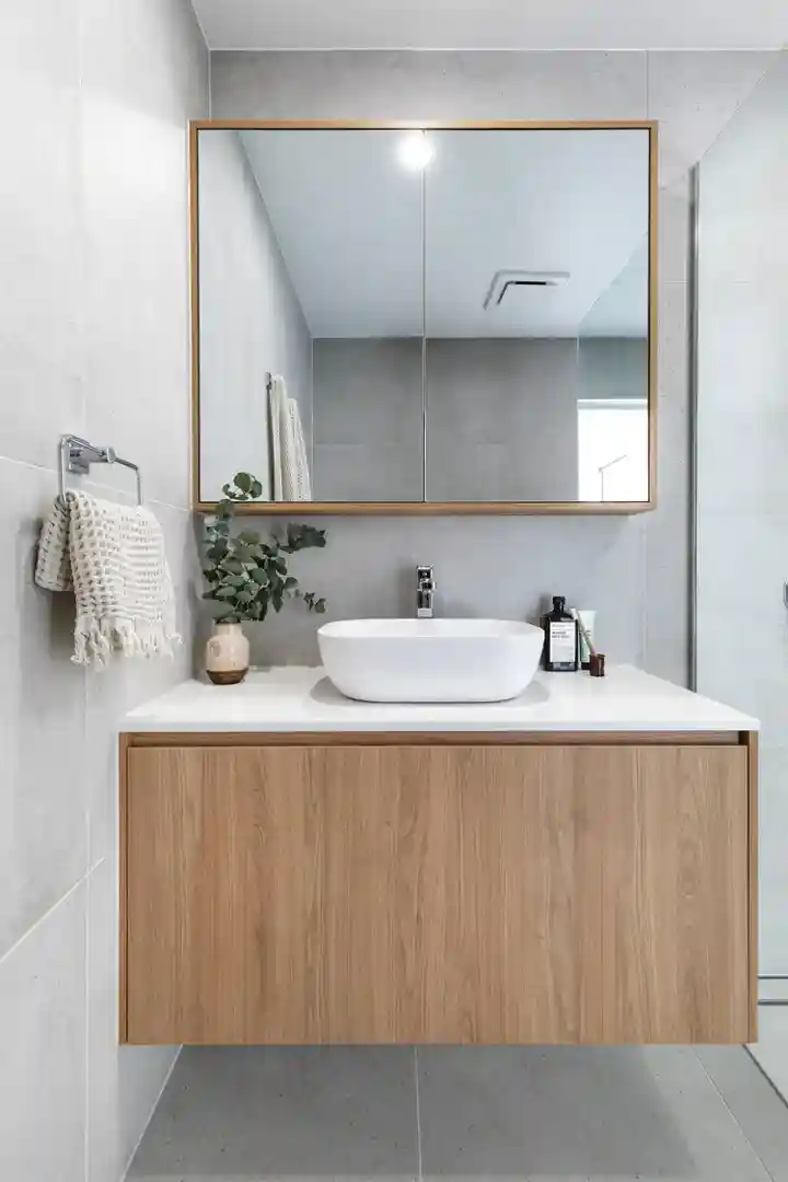 Stylish master ensuite with integrated shaving cabinet, mirror, and modern fittings
