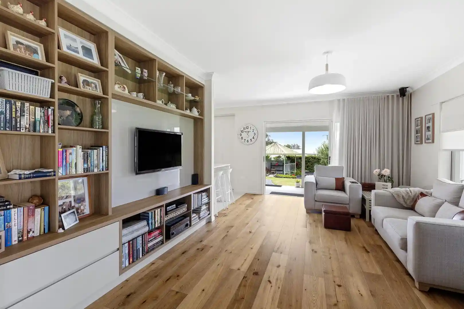 Modern living room featuring a custom-built entertainment centre with storage and display space
