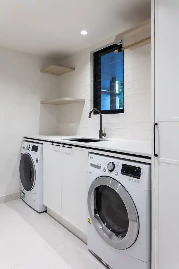 Modern laundry room maximising vertical space with built-in cabinetry