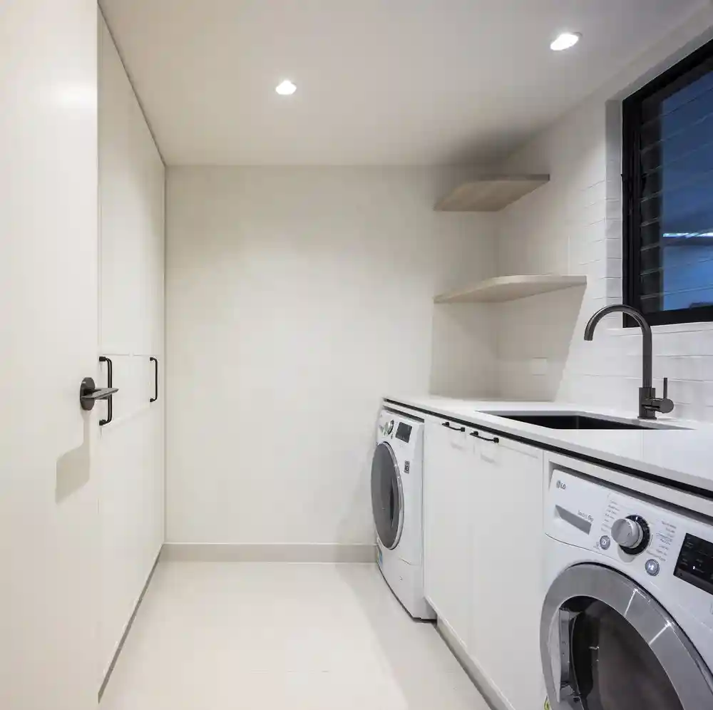 Modern laundry room with custom cabinetry and organised storage solutions