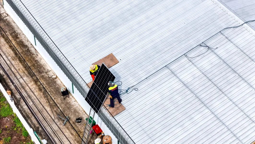 Building inspector reviewing commercial roofing plans for compliance - Roofing Considerations in Southern California