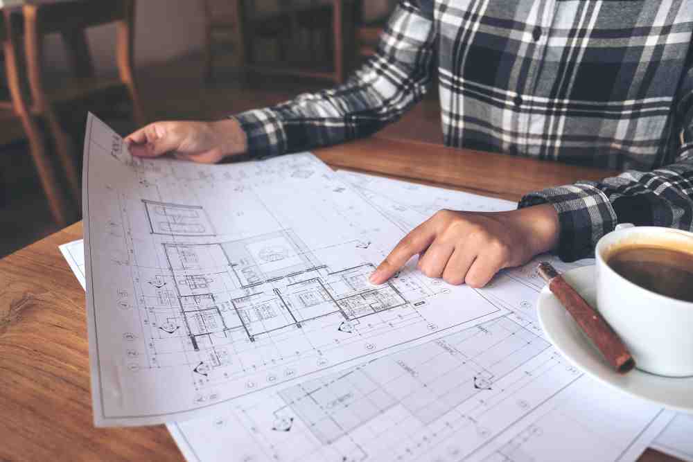 Construction manager reviewing blueprints - speed vs quality Construction manager reviewing blueprints - speed vs quality