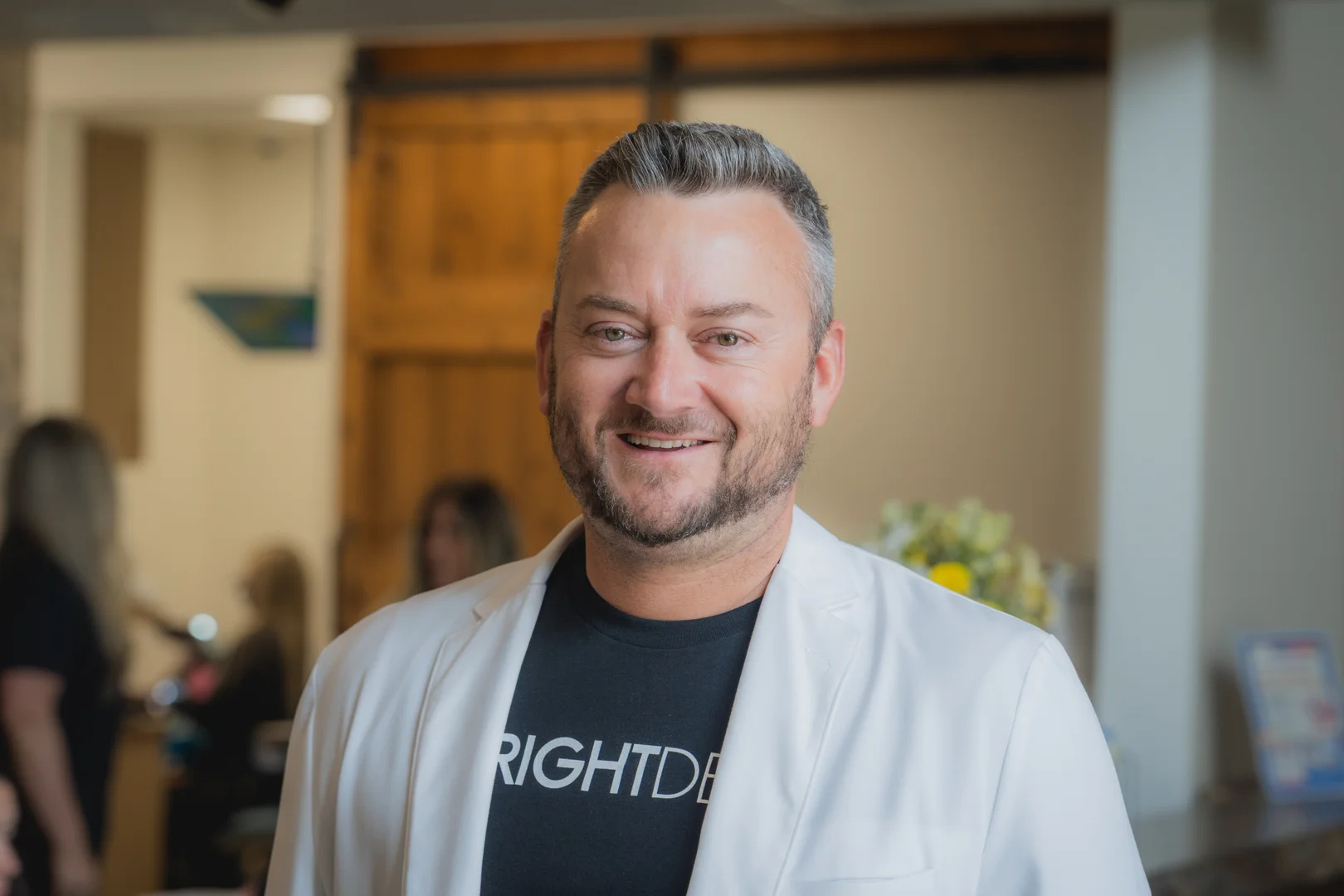 Dr. Justin Wright, DDS, in a white coat at Just Wright Dental and Implant Center, Corsicana TX, discussing same-day full arch treatment options