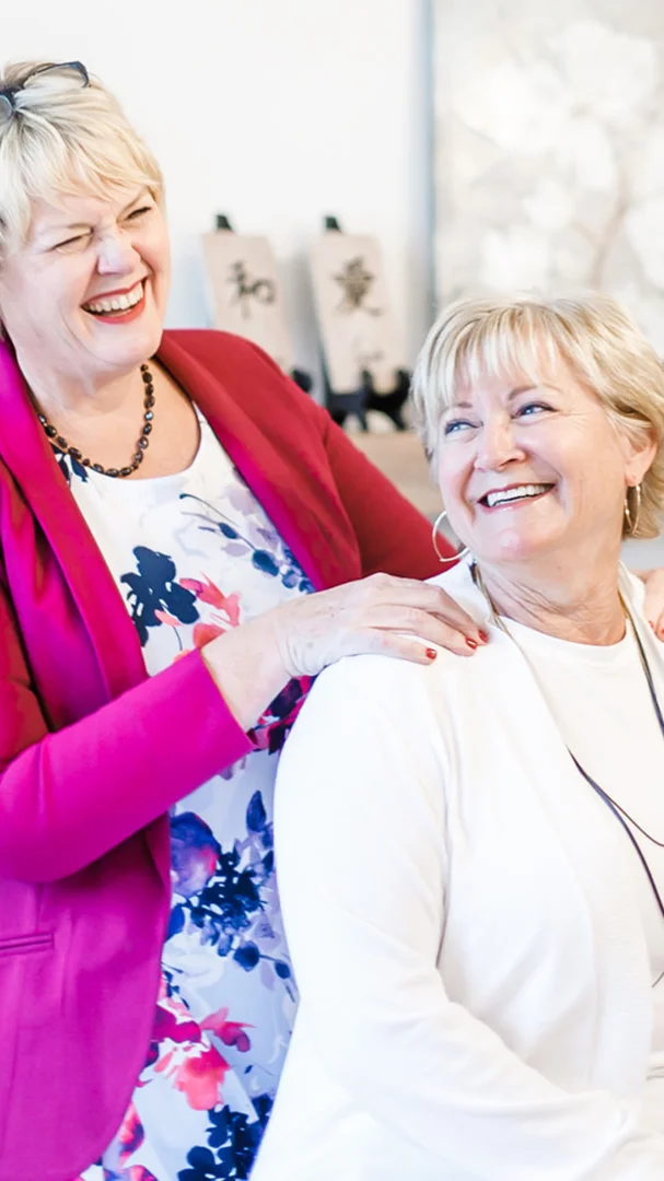 A woman sitting comfortably in a modern clinical setting, representing a non-invasive treatment experience - Menopause