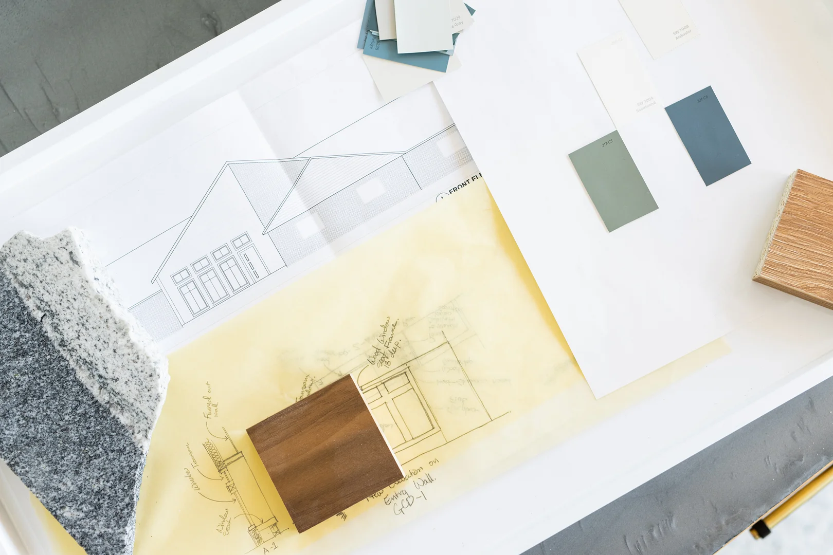 construction documents architectural plan set on wooden table - why you need construction documents before you start a