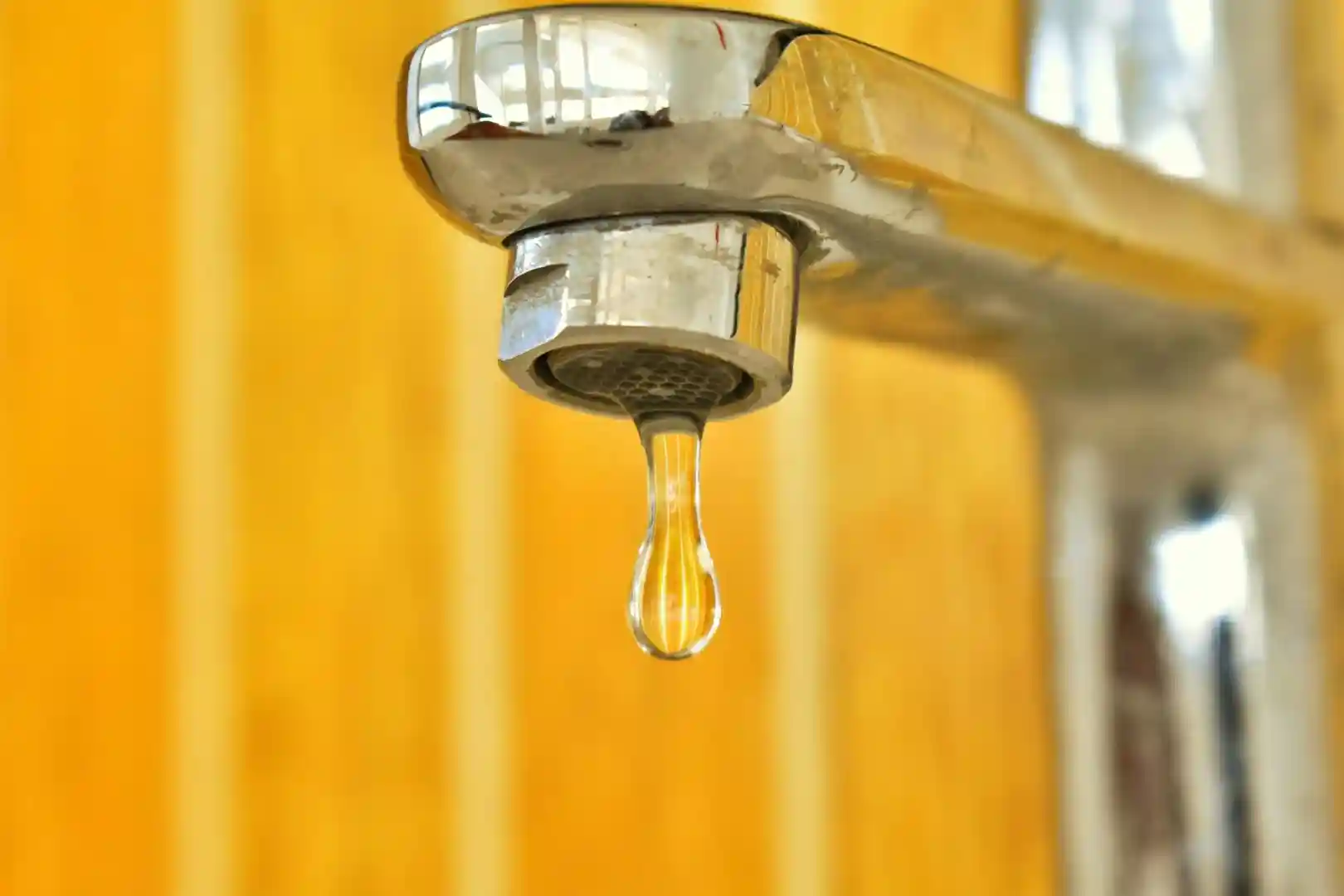 Freshly repaired faucet with water running smoothly into a clean sink - residential plumbing repair near me
