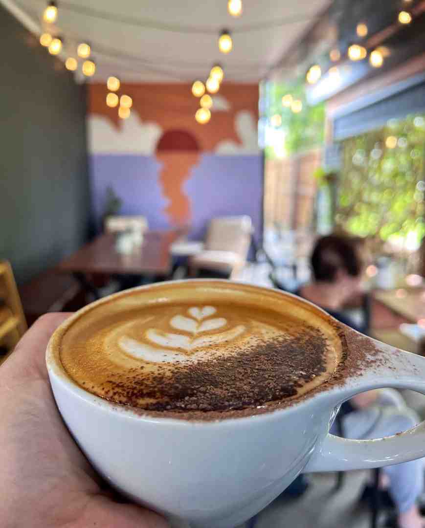 barista pouring latte art - brunch and coffee