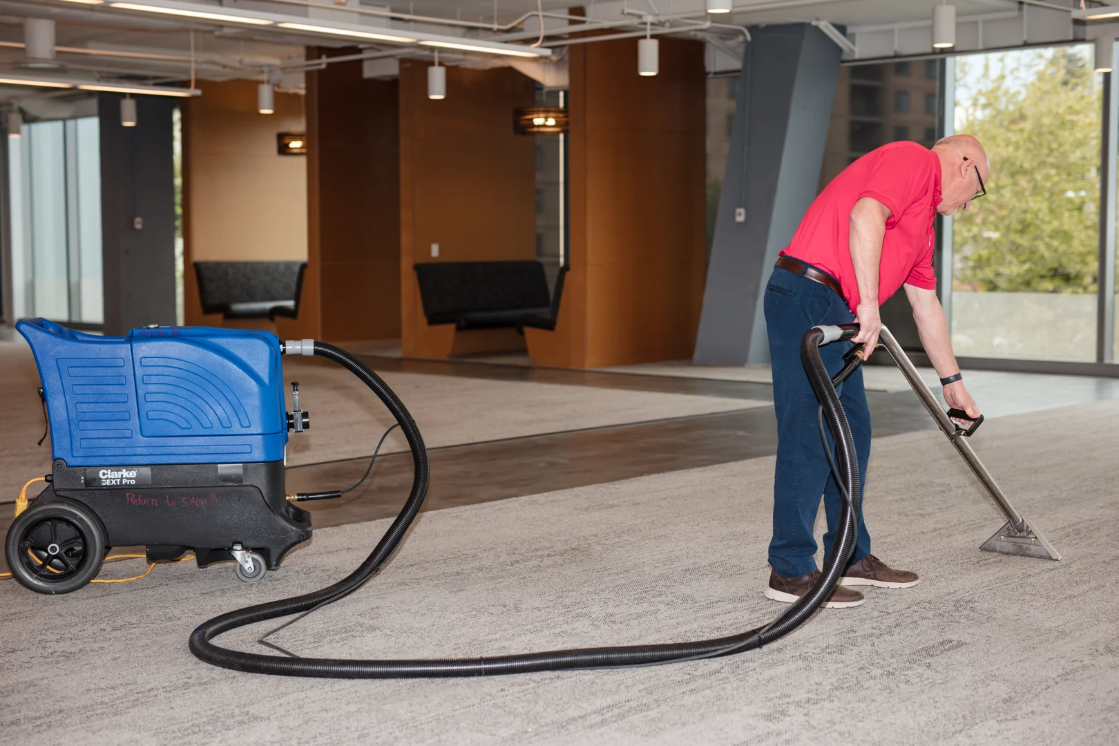 Professional green carpet cleaning in a commercial facility.