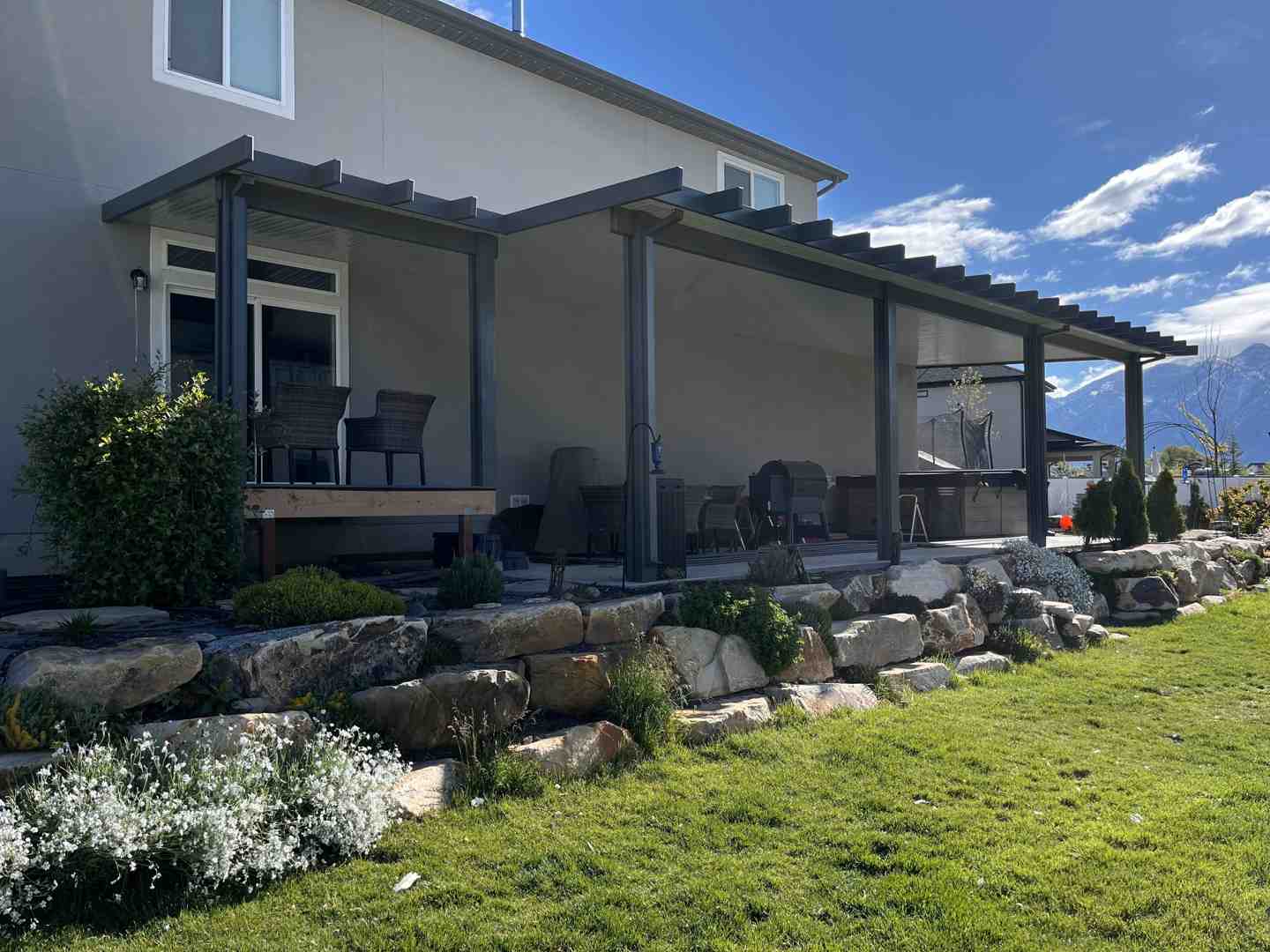 a modern solid patio cover with comfortable seating and lighting - backyard covered area a modern solid patio cover with comfortable seating and lighting - backyard covered area