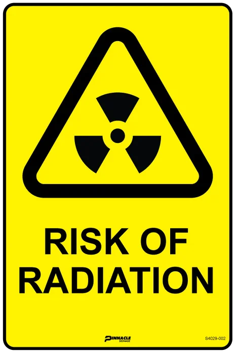 A yellow "Risk of Radiation" warning sign with the trefoil symbol, clearly marking a radiation restricted area.