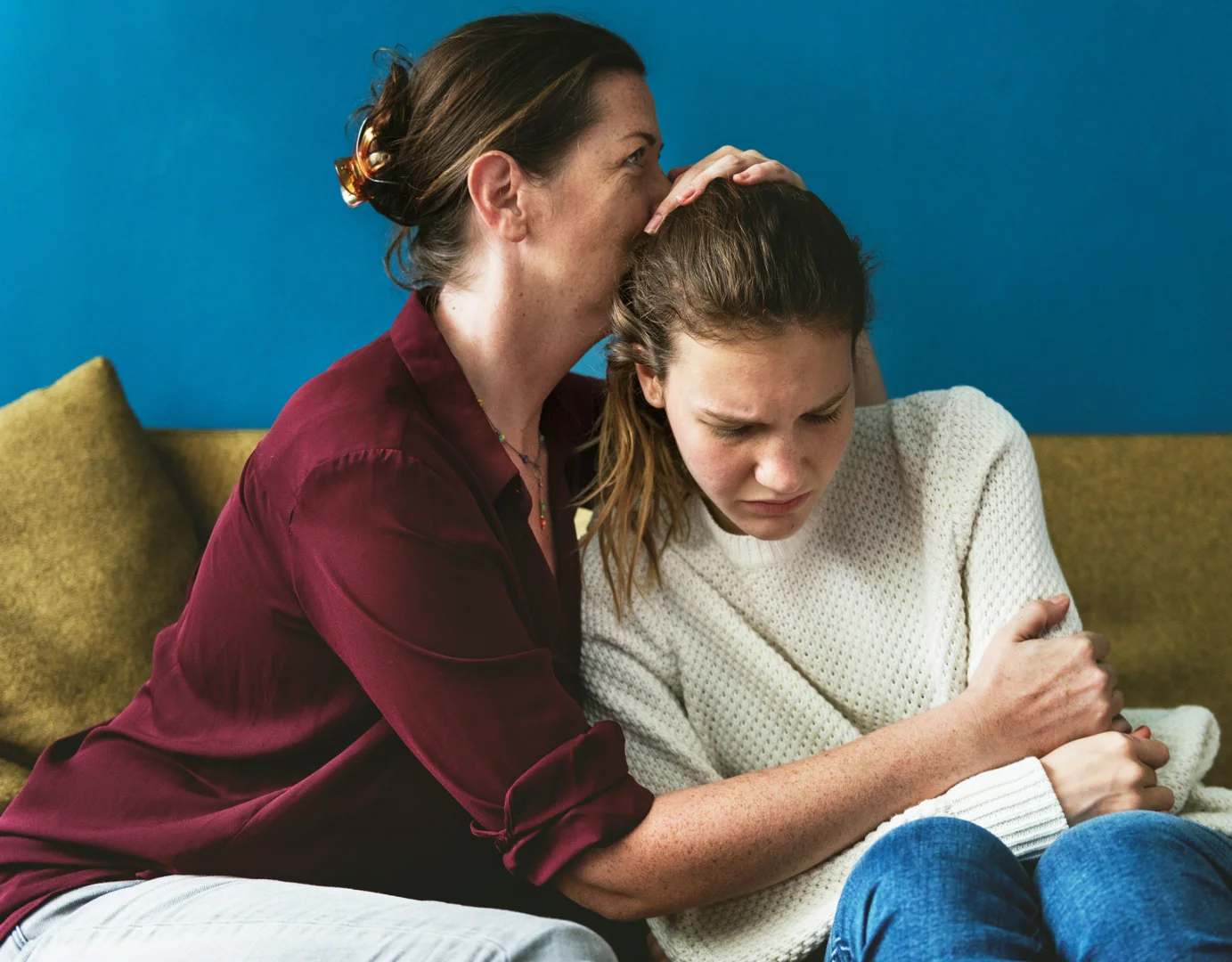 mother and daughter communicating openly in a warm living room setting
