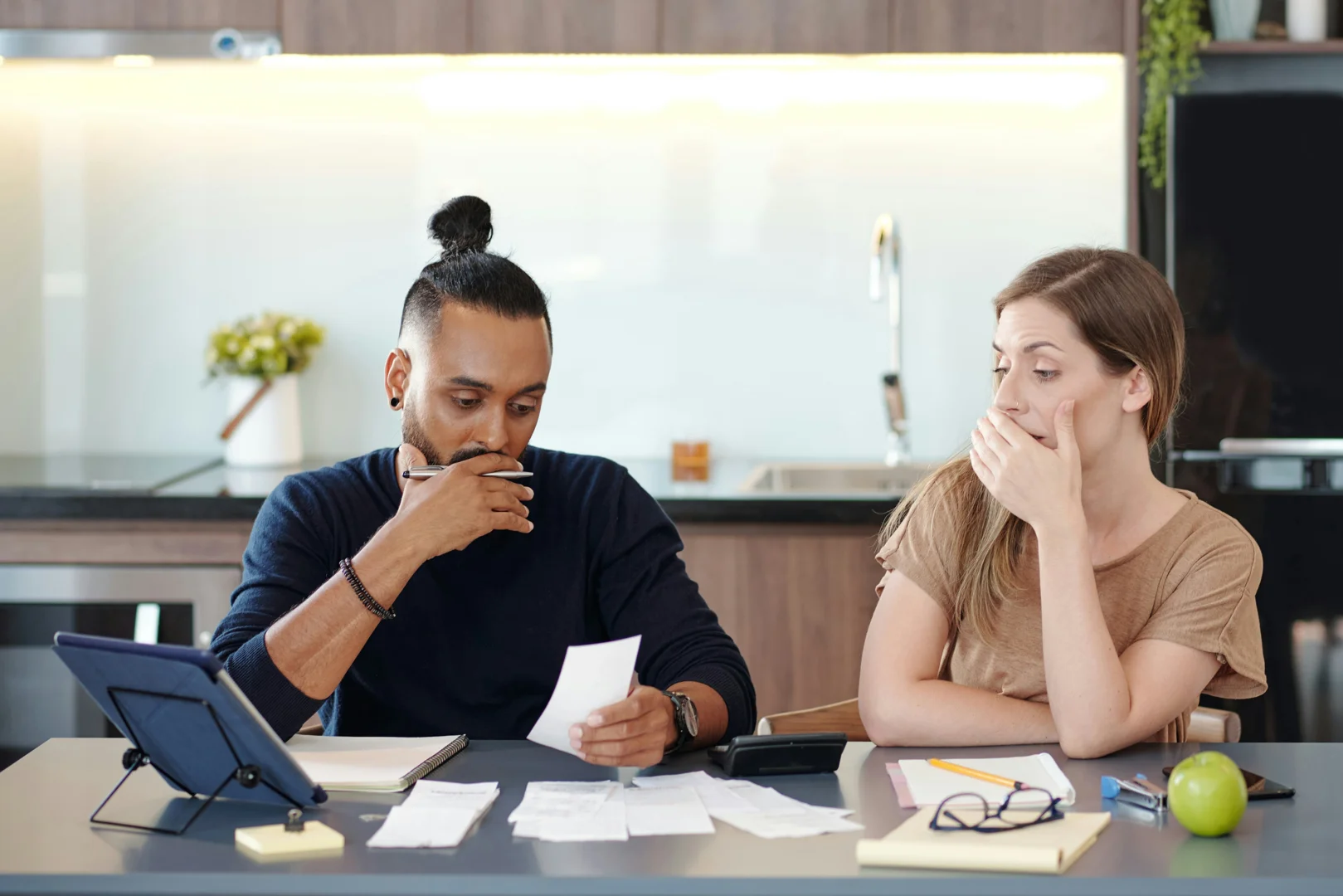 couple working on budget together - premarital counseling questions