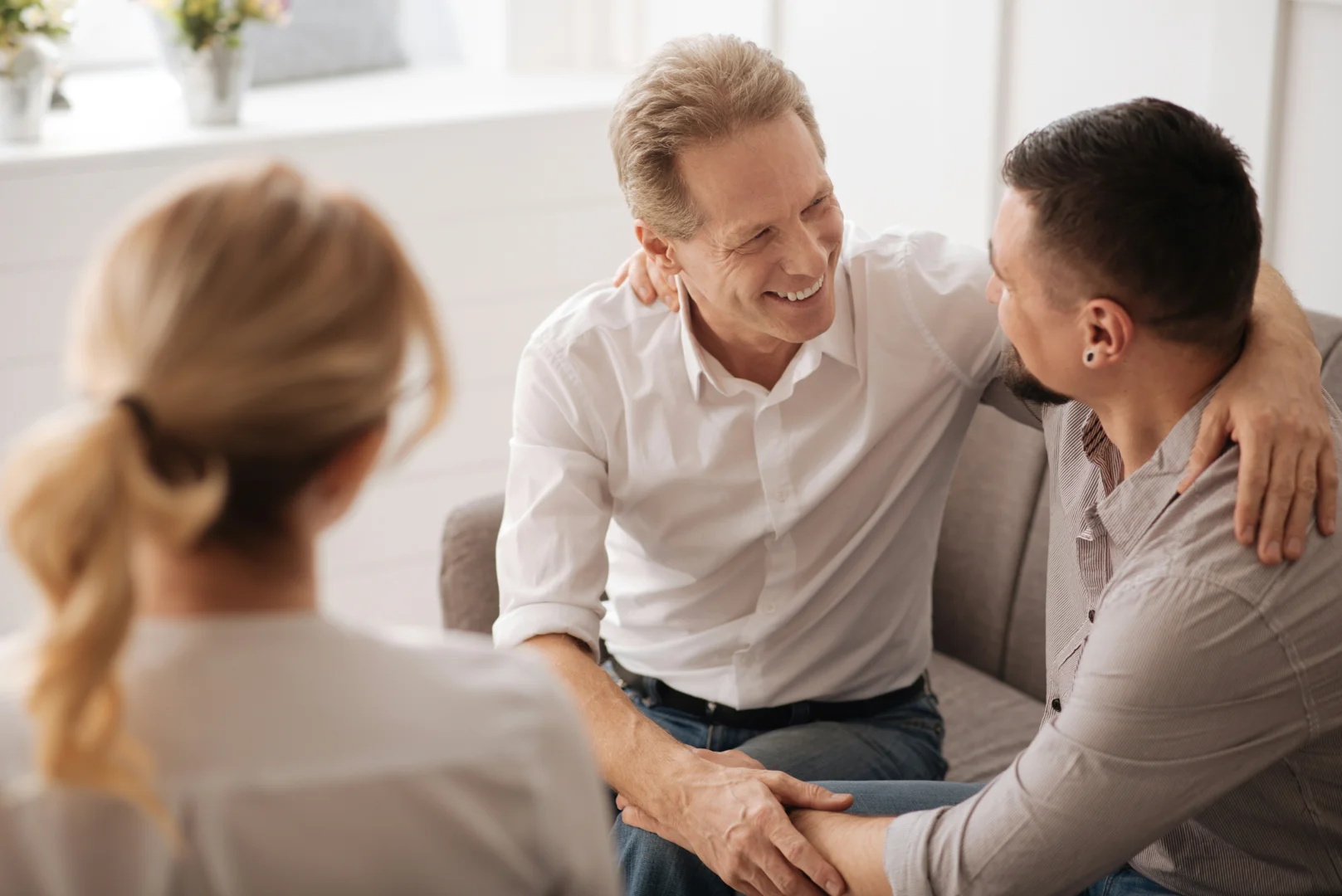 LGBTQ couples therapy - partners discussing connection in a comfortable therapy room