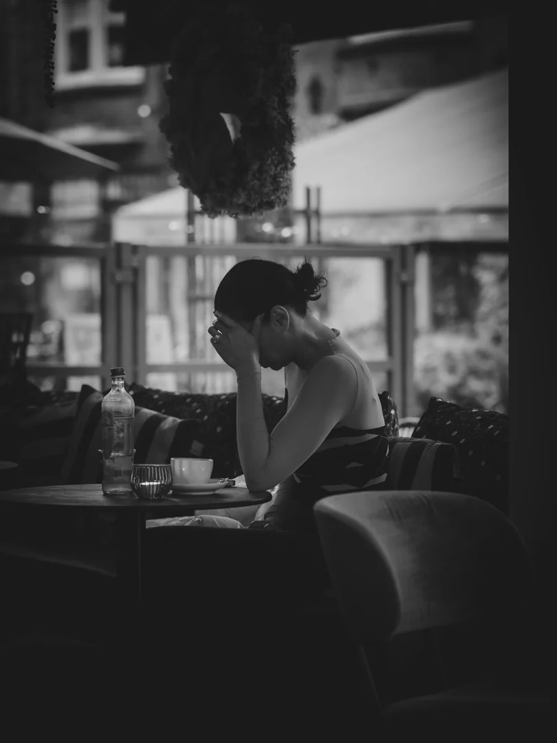 person sitting alone looking at Barcelona cityscape - what do i do if im lonely