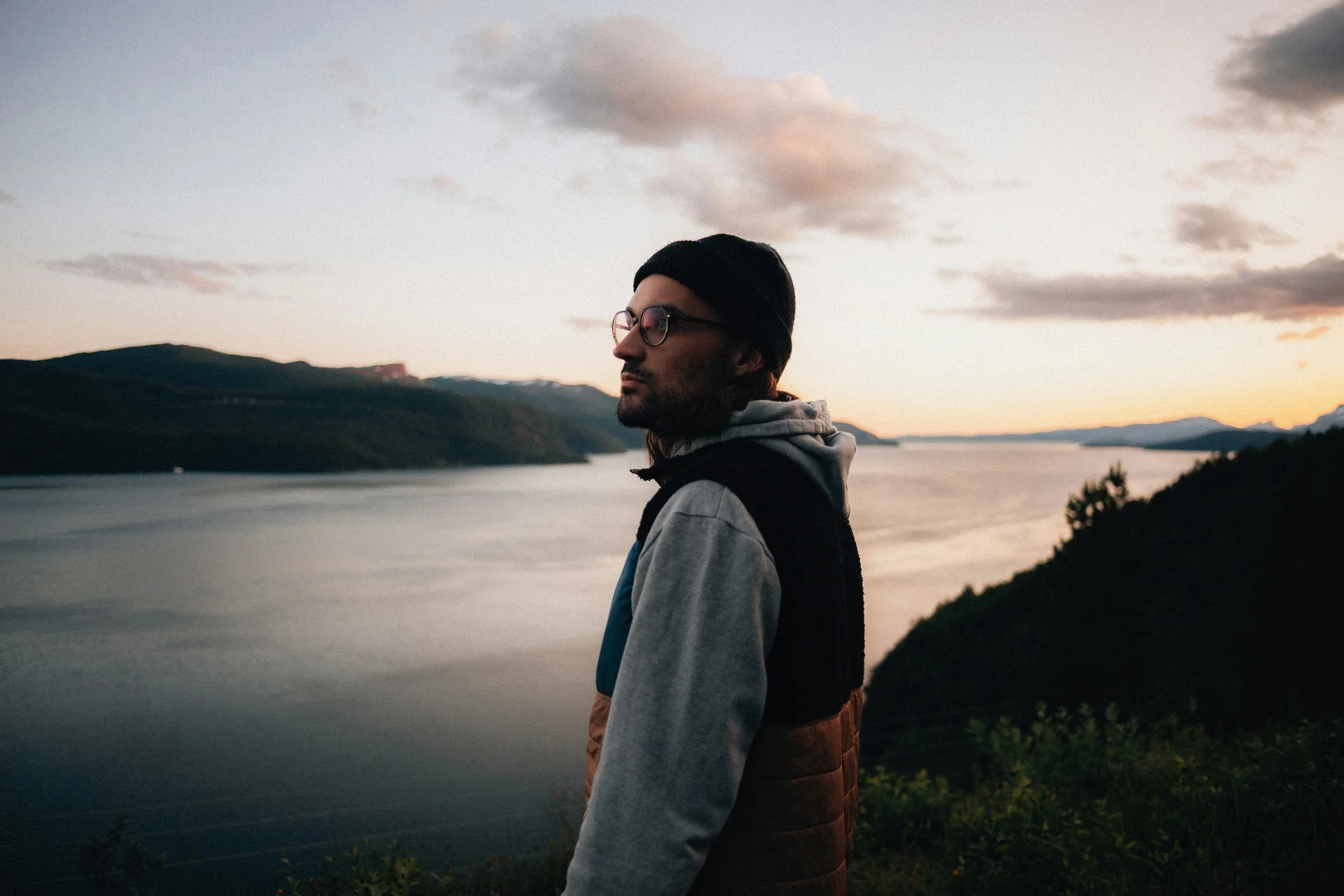 An expat looking out over a new city at sunset, reflecting on their journey