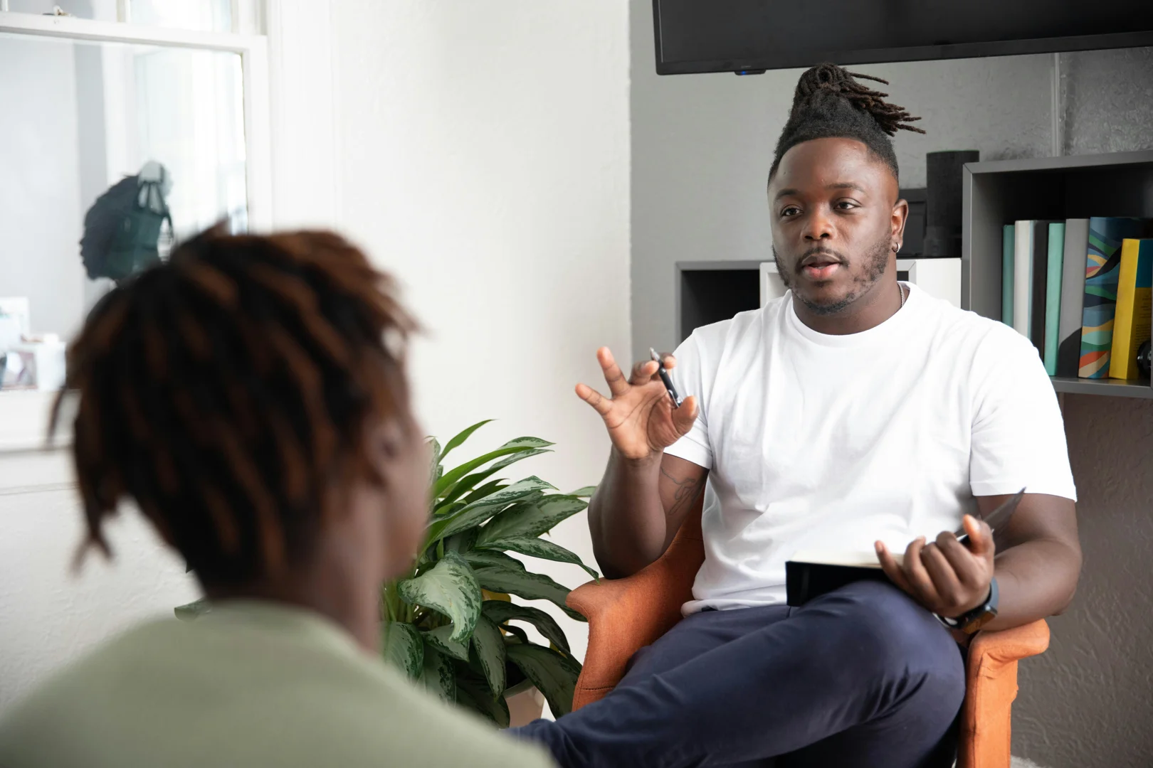 A therapist and client talking warmly in a comfortable office, highlighting connection and safety - therapy for third culture kids A therapist and client talking warmly in a comfortable office, highlighting connection and safety - therapy for third culture kids