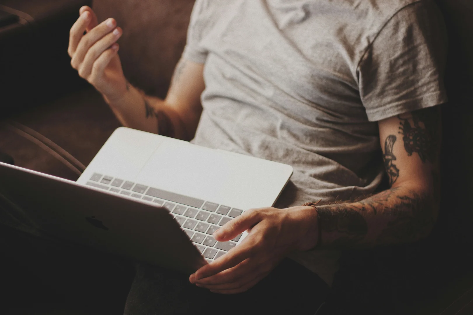 person looking at laptop screen with calm expression, trauma recovery, online healing - Online trauma therapist