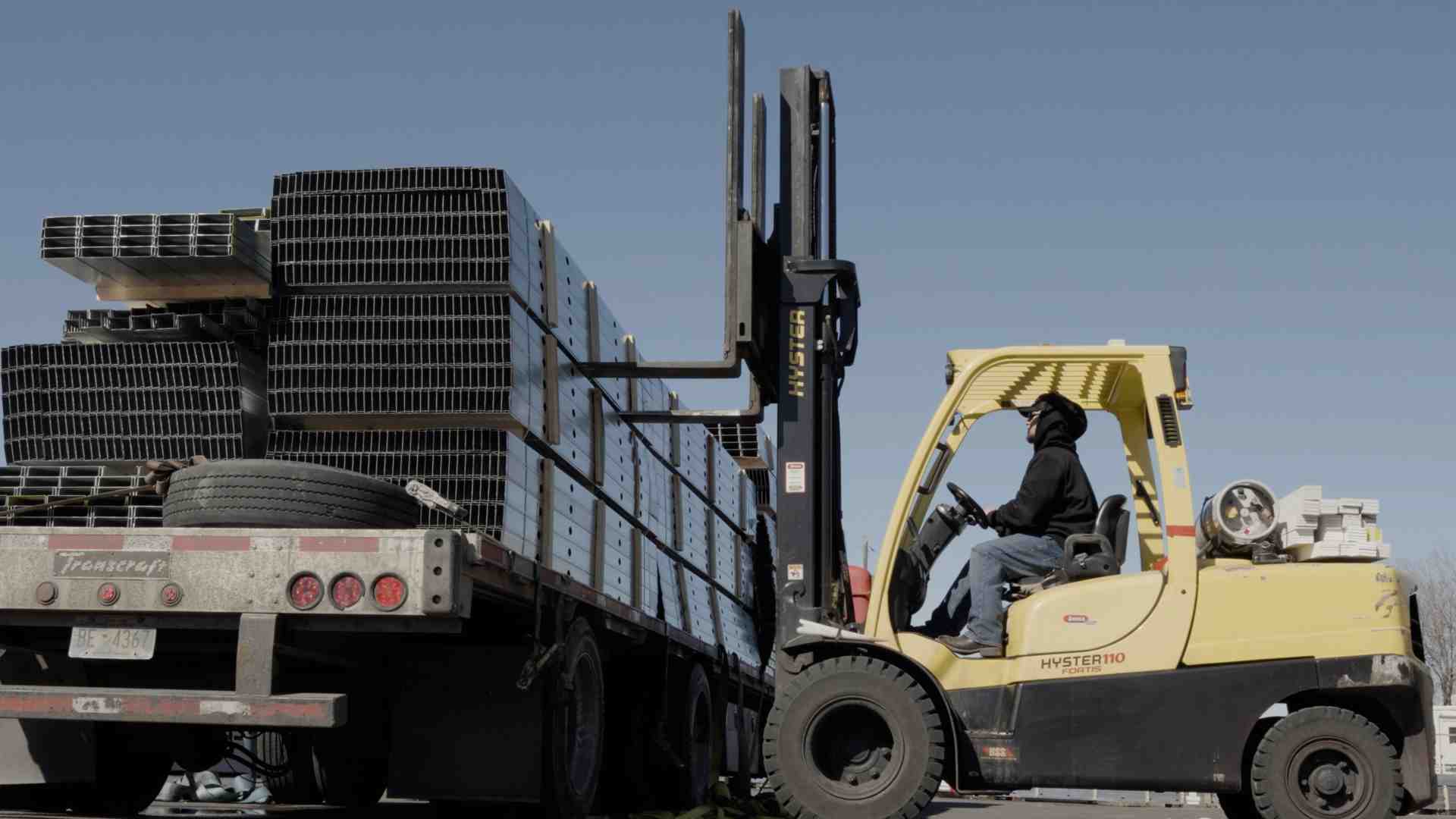 unloading steel studs from a delivery truck unloading steel studs from a delivery truck