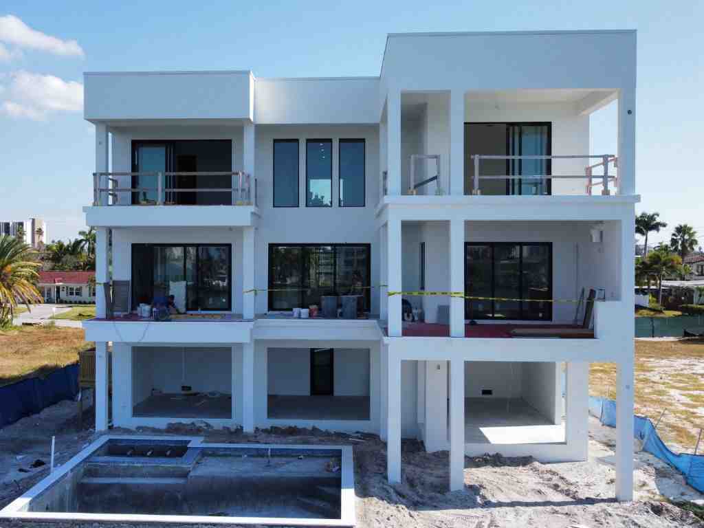 Close-up of stainless steel fasteners on an exterior wood detail against a concrete wall in a coastal home - coastal construction