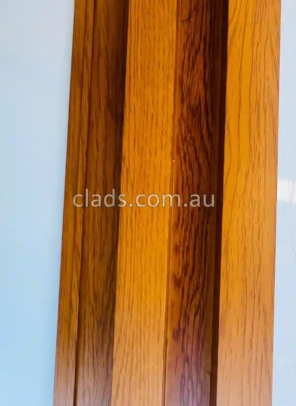 A detailed view of premium, low-maintenance cladding materials australia in a warm wood tone.