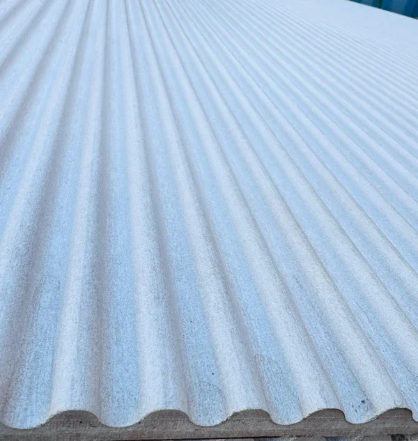 Close-up texture of light blue, vertically oriented, wavy patterned architectural cement cladding panel for feature walls.