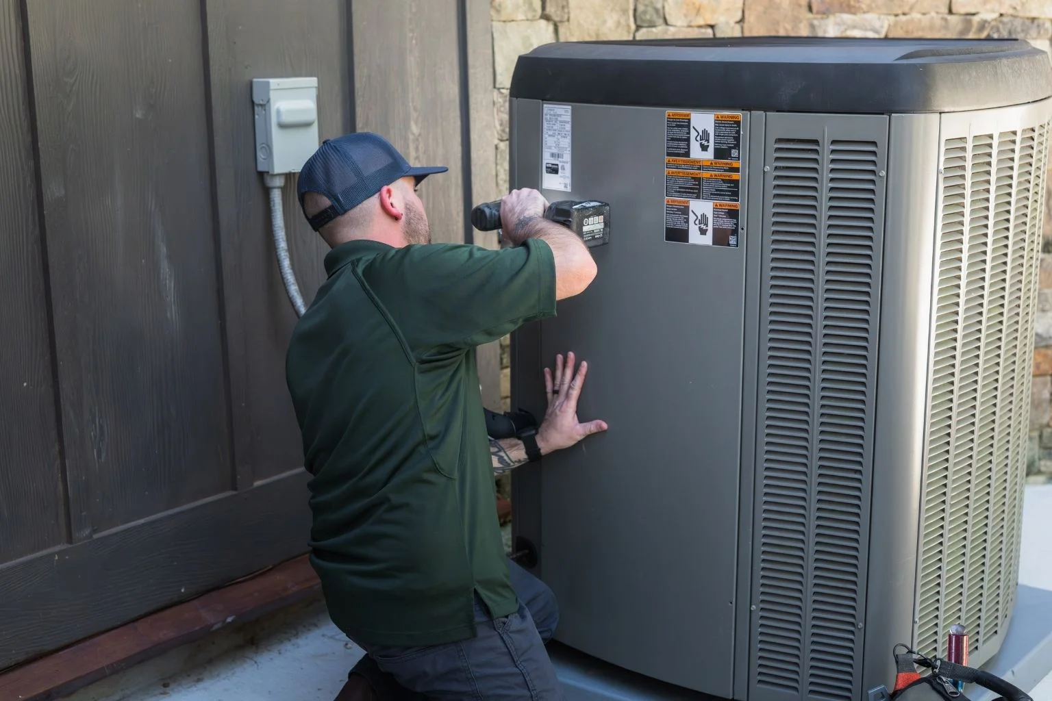 Technician replacing AC unit, indicating a potential need for replacement.