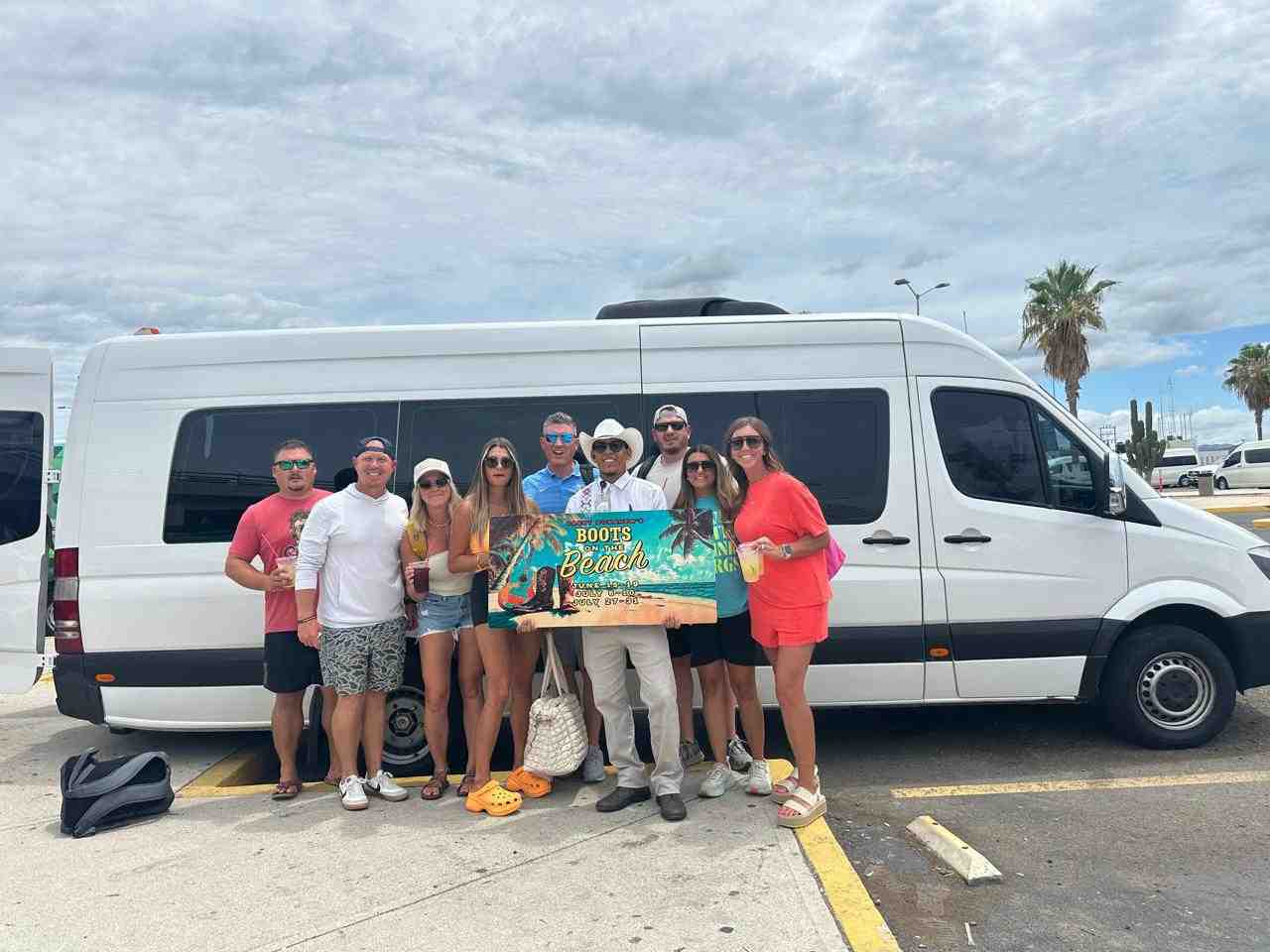 A large group happily boarding a Mercedes Sprinter van - private car service cabo san lucas