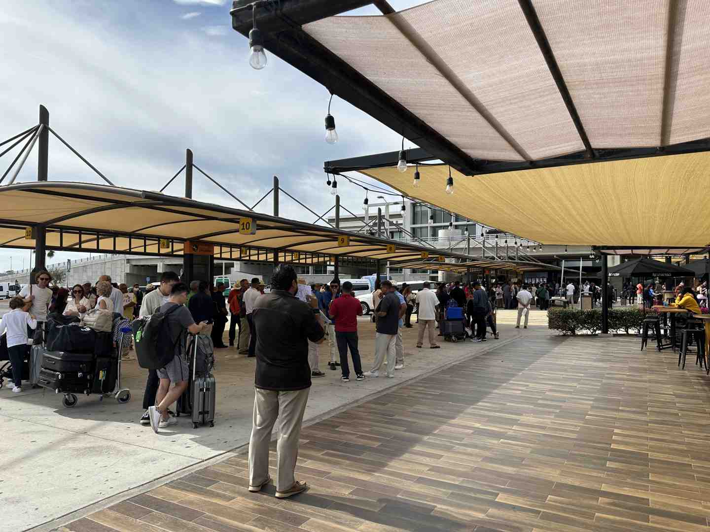 Image of a family with luggage and a child seat being loaded into a private van - airport transfer cabo