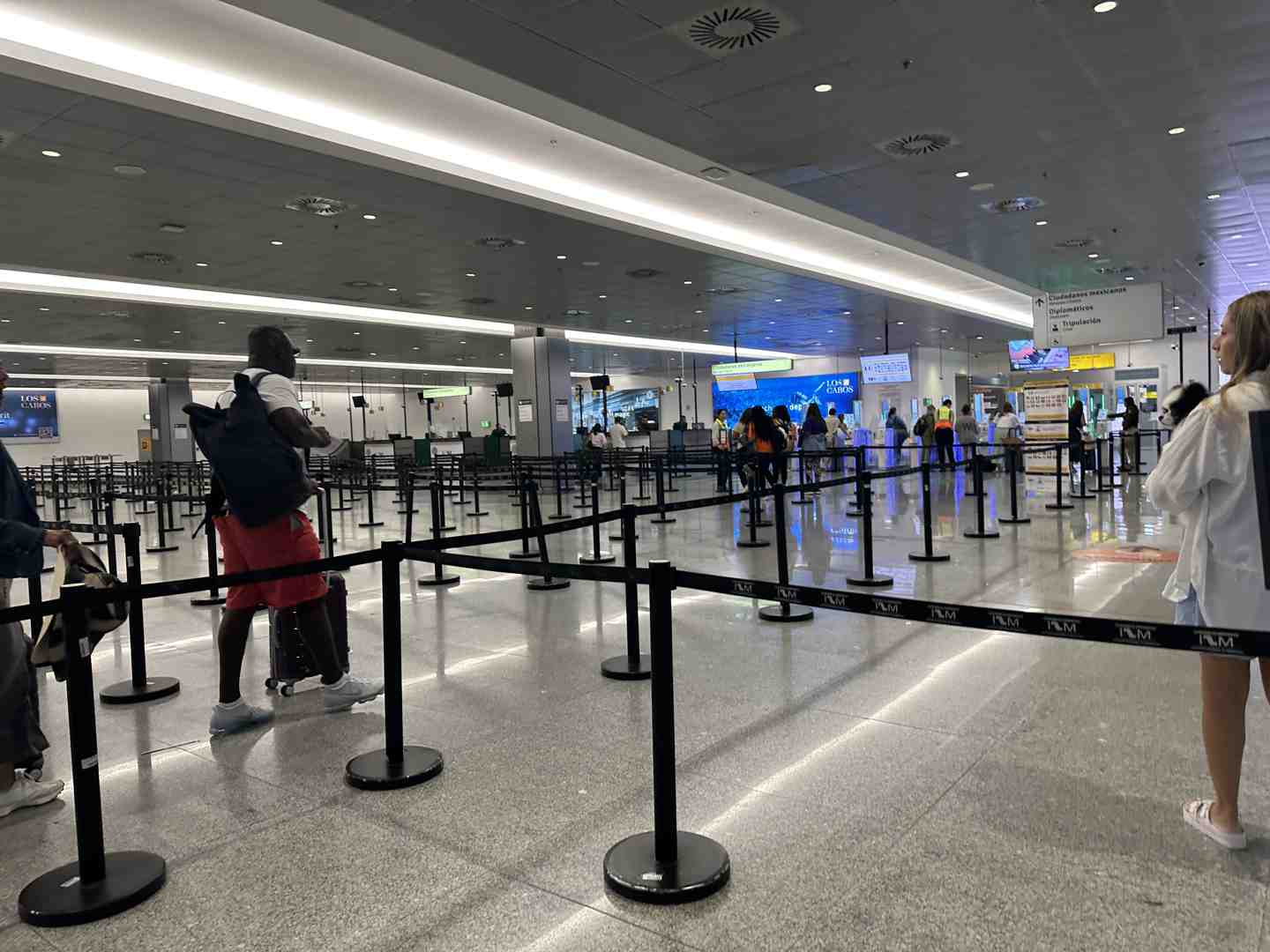 Modern airport terminal interior with check-in counters and seating areas - cabo san lucas international airport