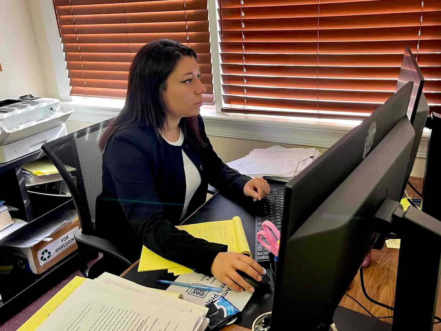 Image of a person reviewing complex insurance documents at a desk