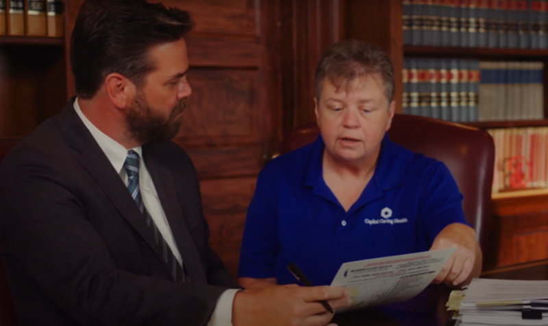 doctor reviewing an x-ray of a broken bone with a patient - Virginia slip and fall